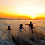 Children playing waves on the beach of Sawarna