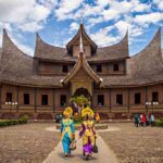 Pagaruyung Palace with a traveller dressing Traditional Minangkabau bidal