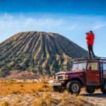 In the top of Jeep Hardtop view Mount Batok in Bromo
