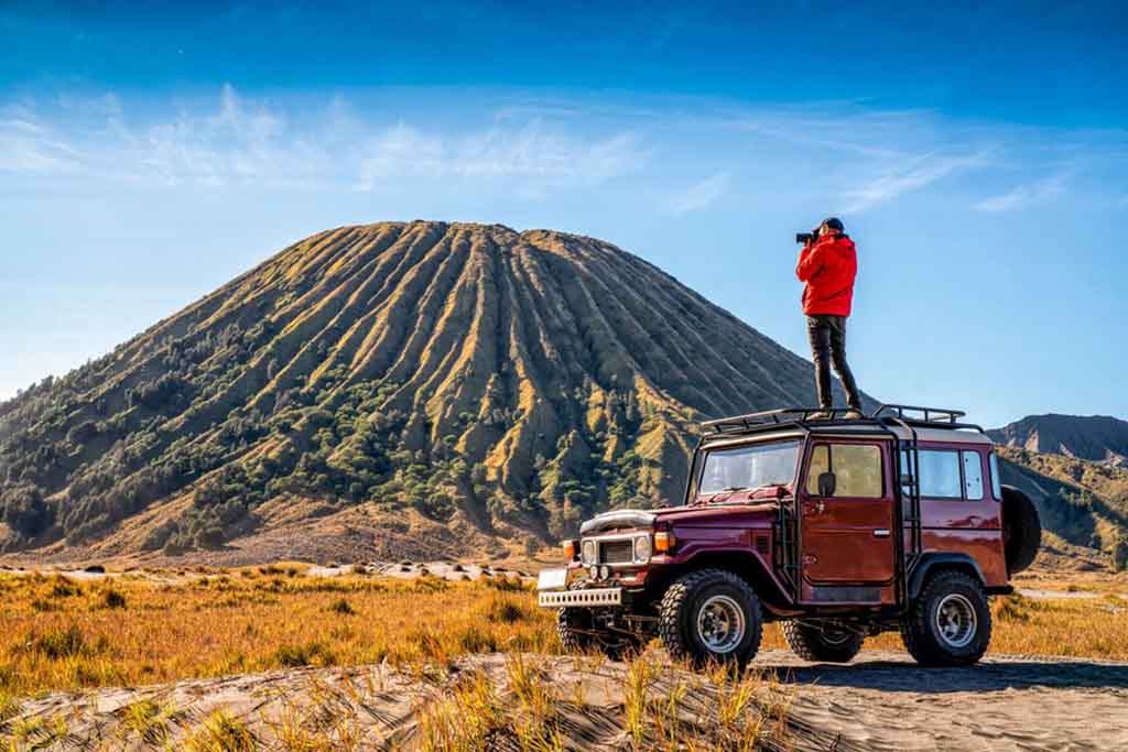 In the top of Jeep Hardtop view Mount Batok in Bromo